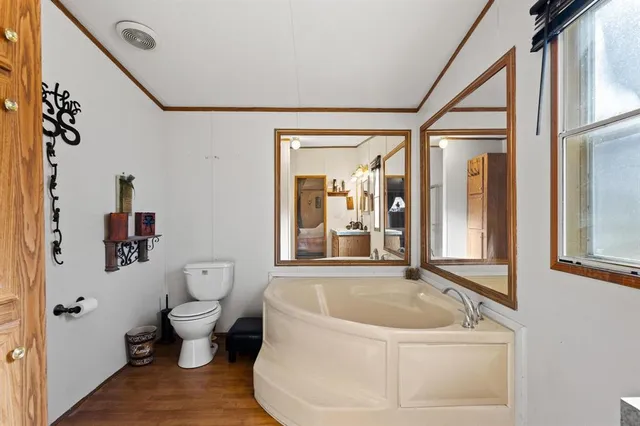 a white bath tub sitting next to a toilet