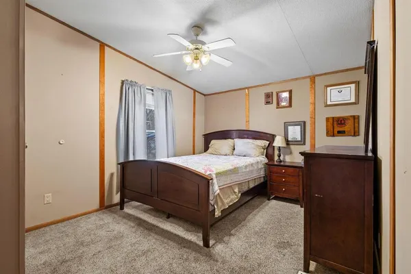 a bedroom with a large bed and a chandelier