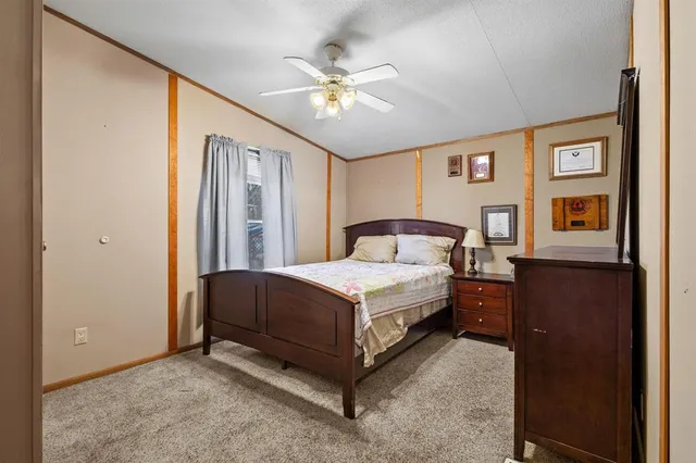 a bedroom with a large bed and a chandelier