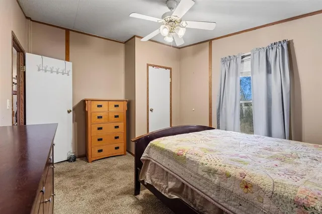 a bedroom with a bed dresser and a window