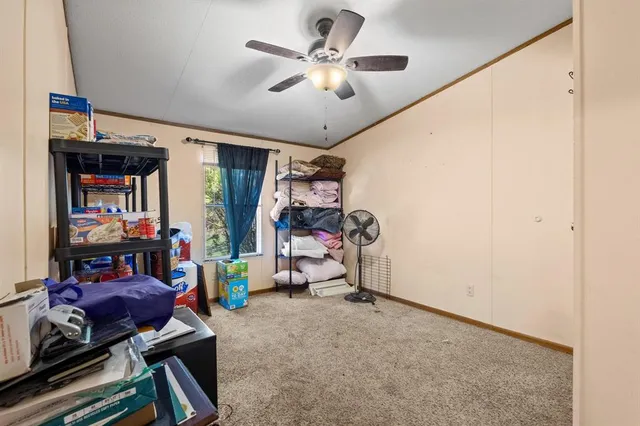a view of play room with toys and a ceiling fan