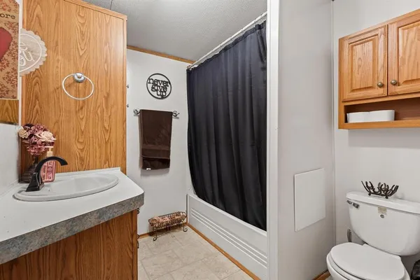 a view of bathroom with a sink and mirror