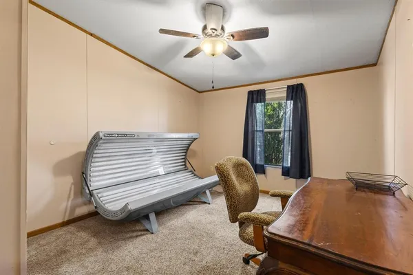a view of a workspace with furniture and a window