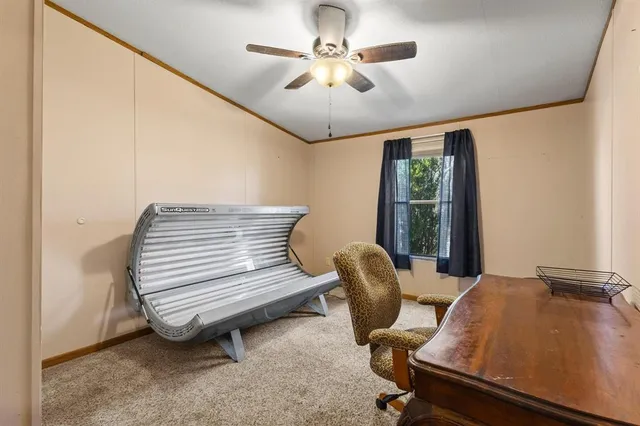 a view of a workspace with furniture and a window