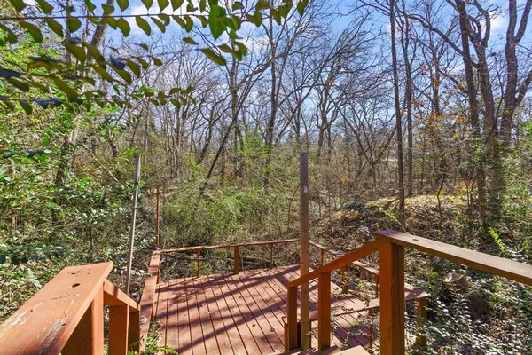 a view of a balcony with wooden fence and floor