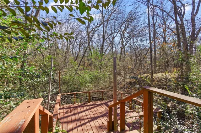 a view of a balcony with wooden fence and floor