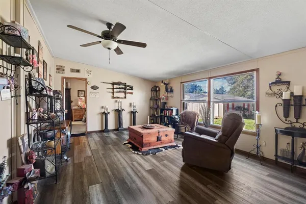 a room with furniture ceiling fan and a window