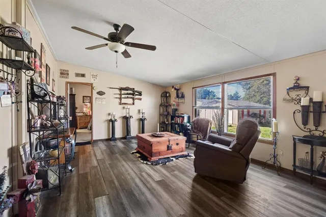 a room with furniture ceiling fan and a window