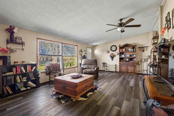 a living room with furniture and a wooden floor