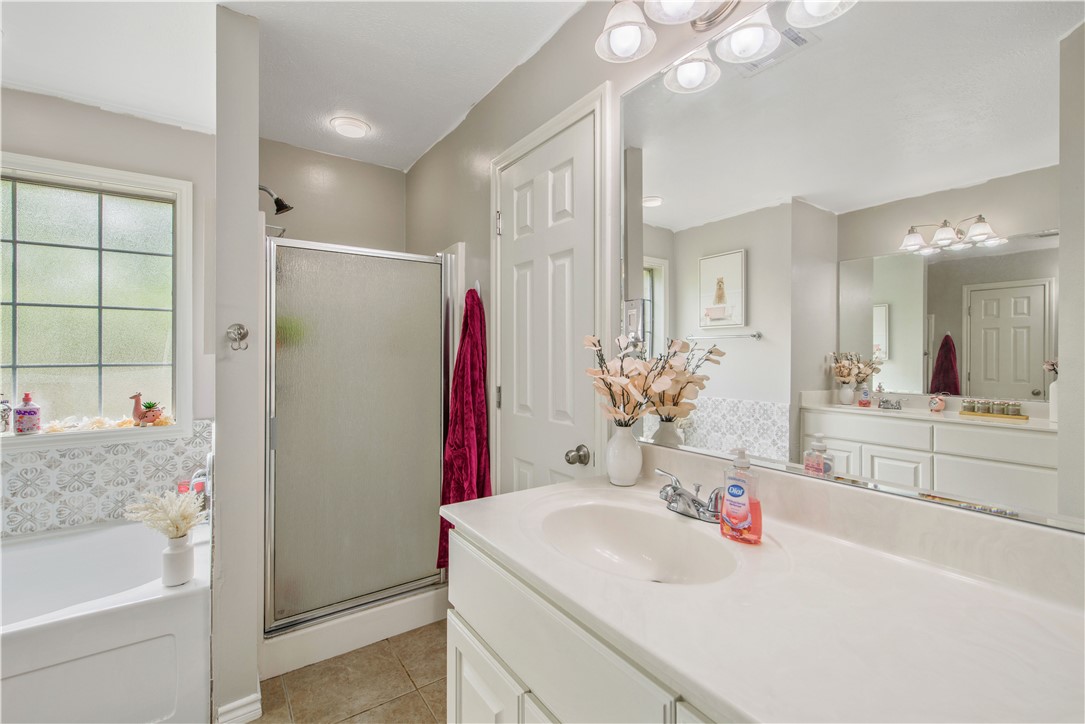 6538 Olympia Buddy Road College Station, TX 77845 - Photo 23 of 50 a bathroom with a tub sink and mirror