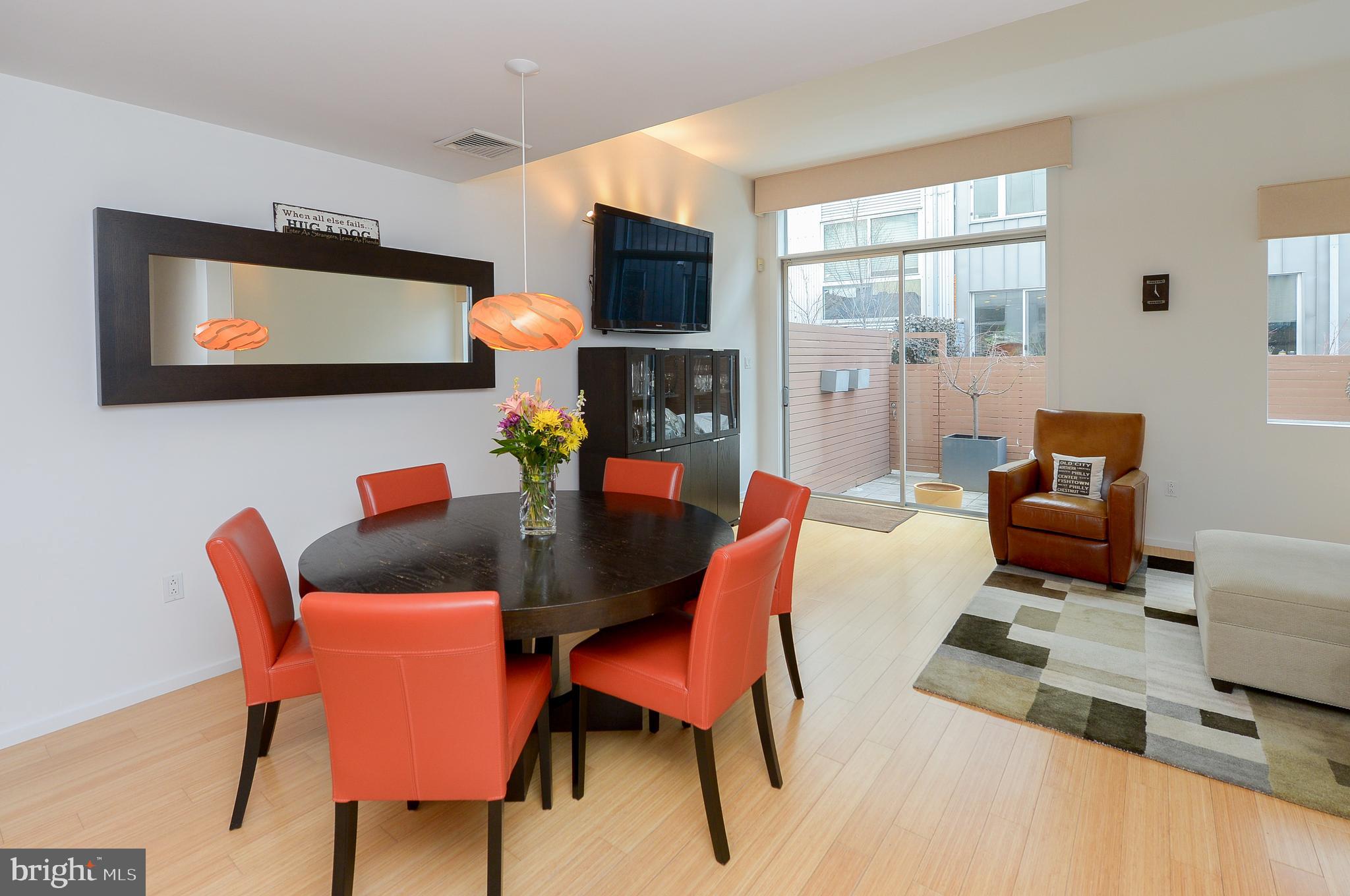 1119 North 3rd Street Philadelphia, PA 19123 - Photo 12 of 46 a dining room with furniture a flat screen tv and a window