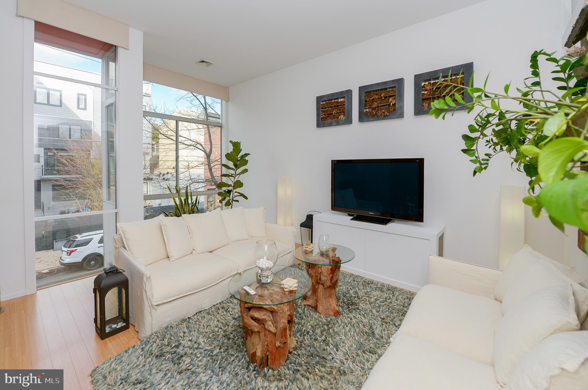 1119 North 3rd Street Philadelphia, PA 19123 - Photo 19 of 46 a living room with furniture a flat screen tv and a fireplace