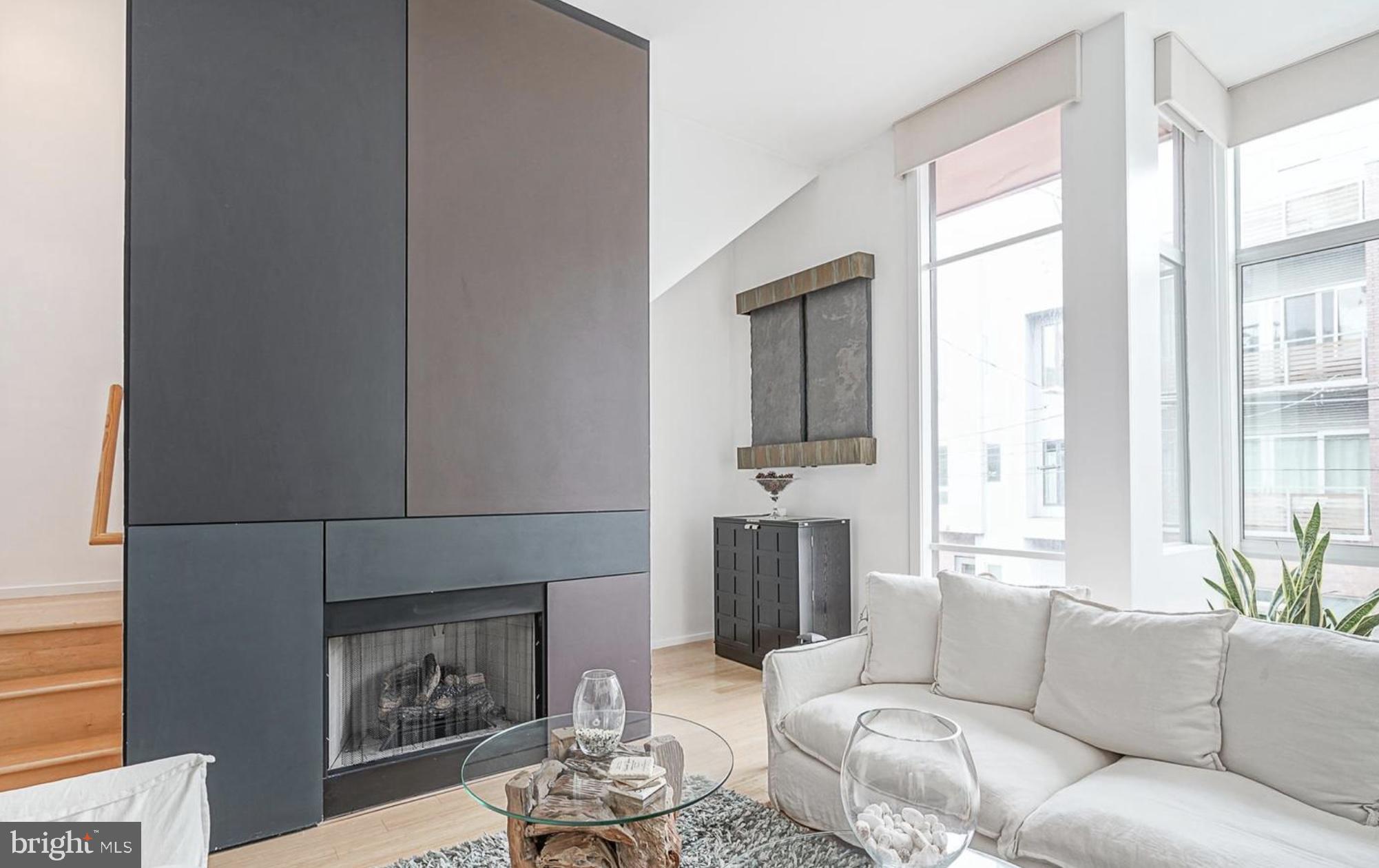 1119 North 3rd Street Philadelphia, PA 19123 - Photo 20 of 46 a living room with furniture and a fireplace