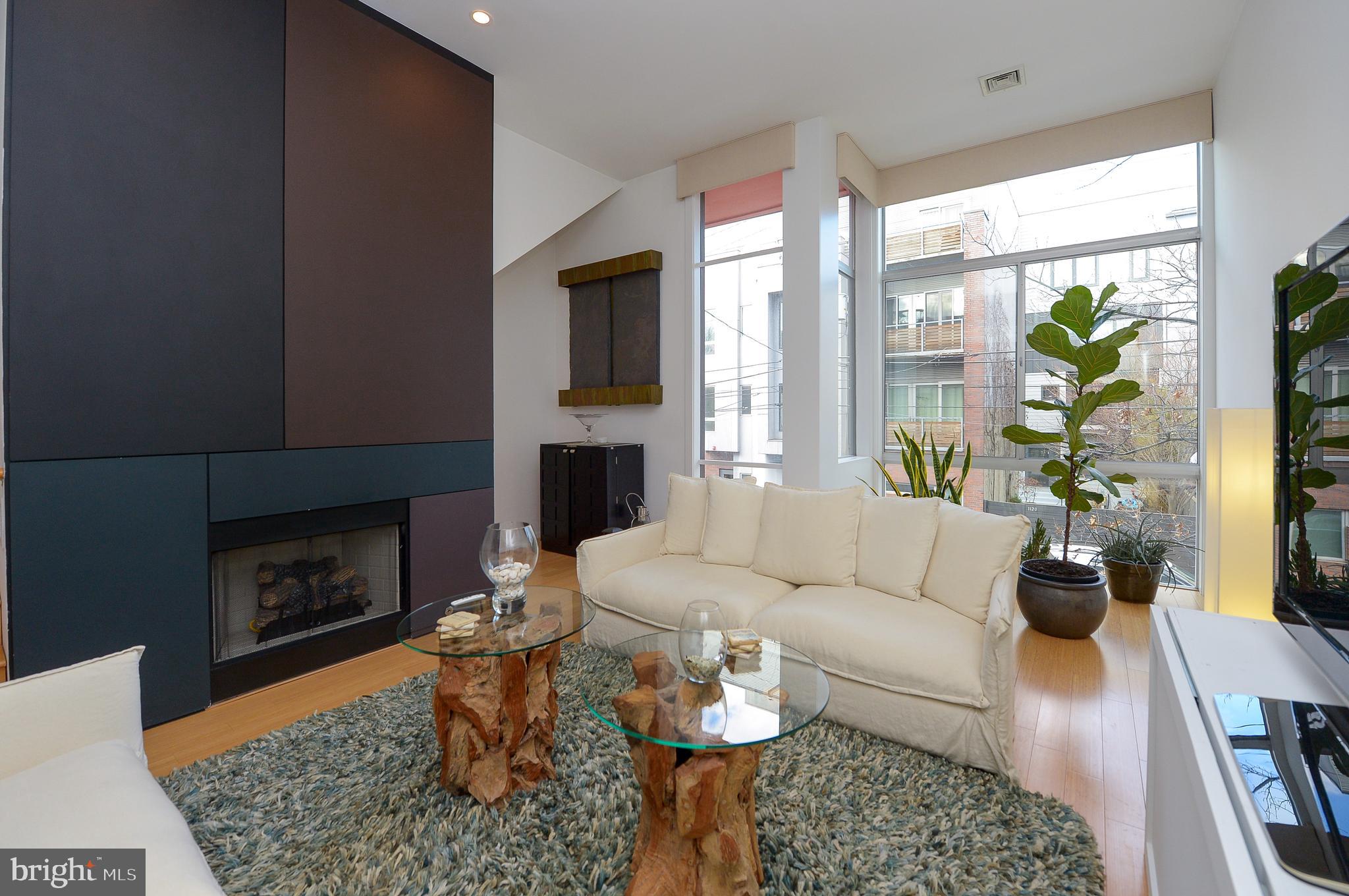 1119 North 3rd Street Philadelphia, PA 19123 - Photo 22 of 46 a living room with furniture a fireplace and a table