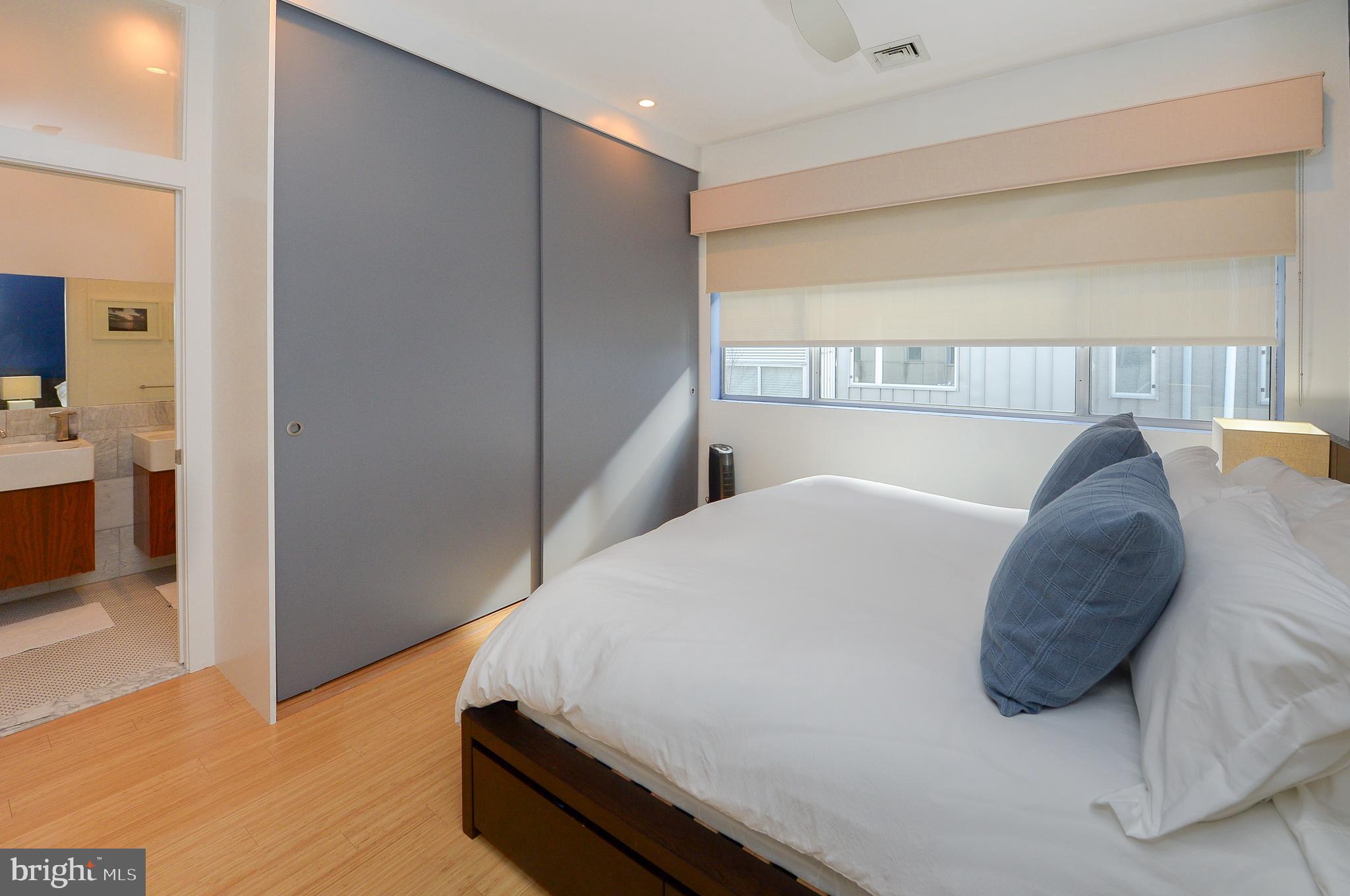 1119 North 3rd Street Philadelphia, PA 19123 - Photo 23 of 46 a bed sitting in a bedroom next to a window with kitchen