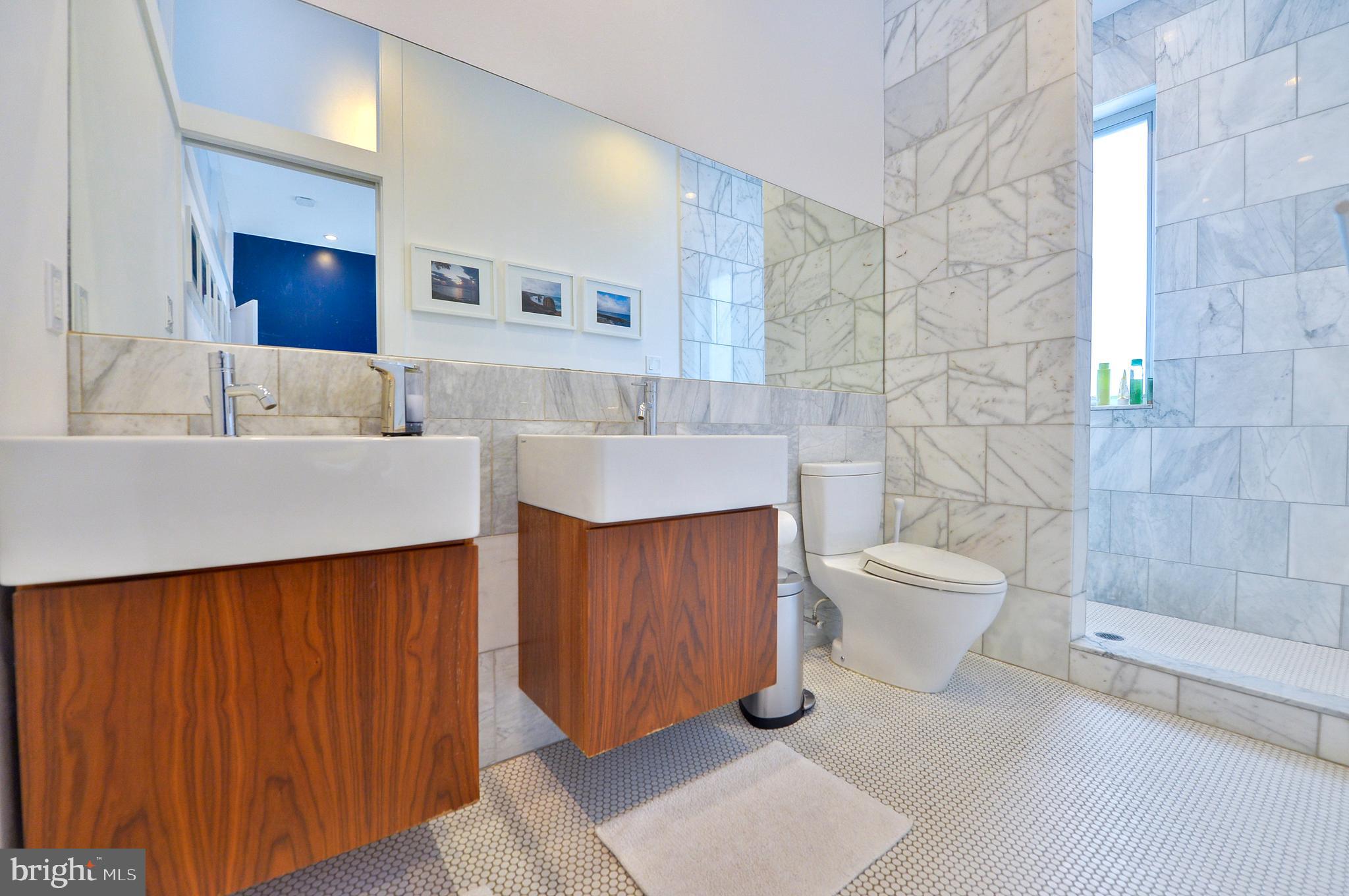 1119 North 3rd Street Philadelphia, PA 19123 - Photo 25 of 46 a bathroom with a toilet a sink and mirror