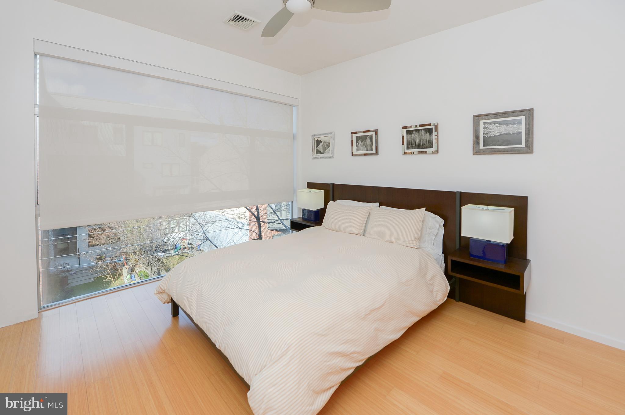 1119 North 3rd Street Philadelphia, PA 19123 - Photo 26 of 46 a large bed sitting in a bedroom next to a window with a chandelier