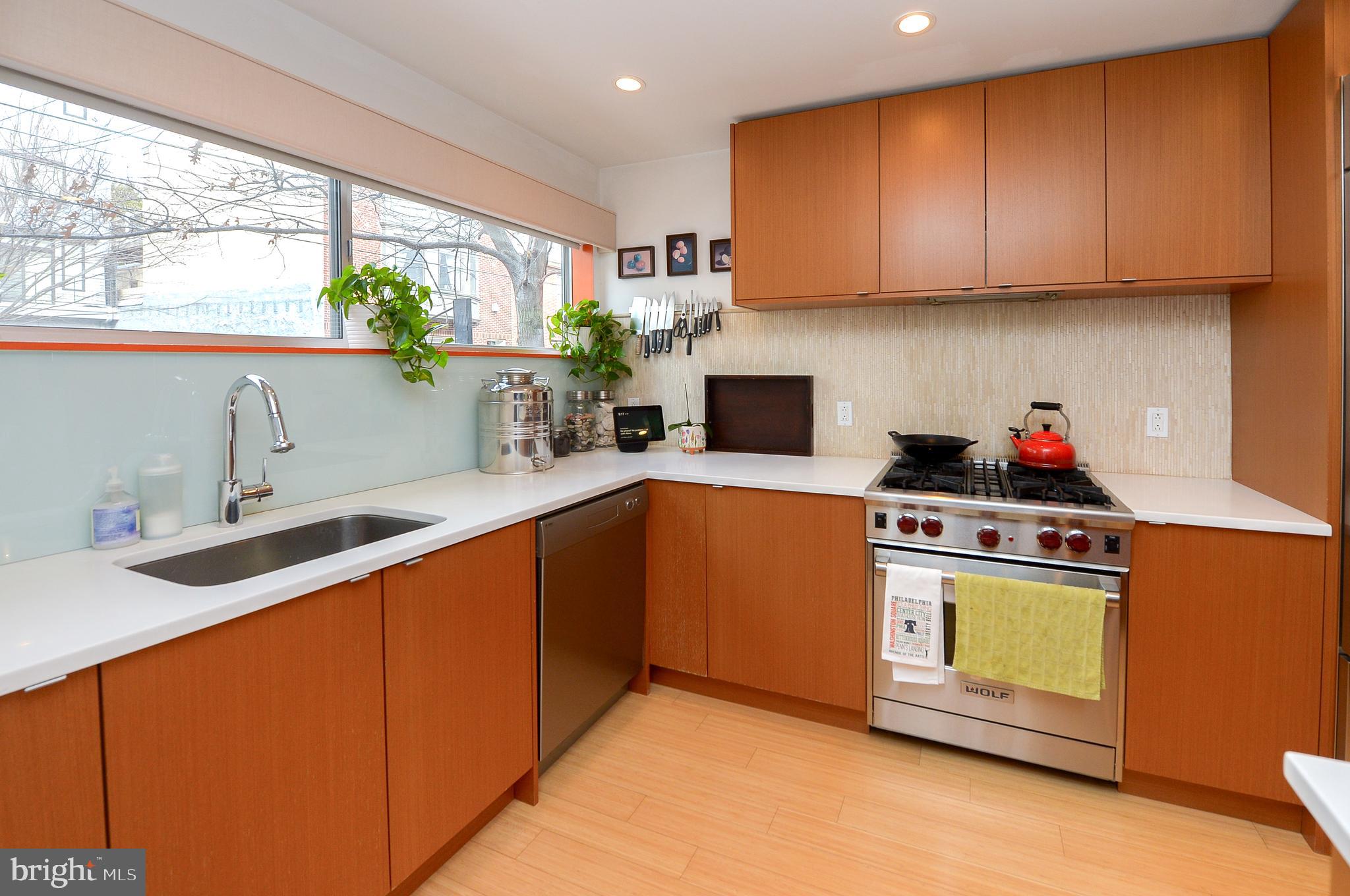 1119 North 3rd Street Philadelphia, PA 19123 - Photo 4 of 46 a kitchen with stainless steel appliances a stove a sink and a microwave
