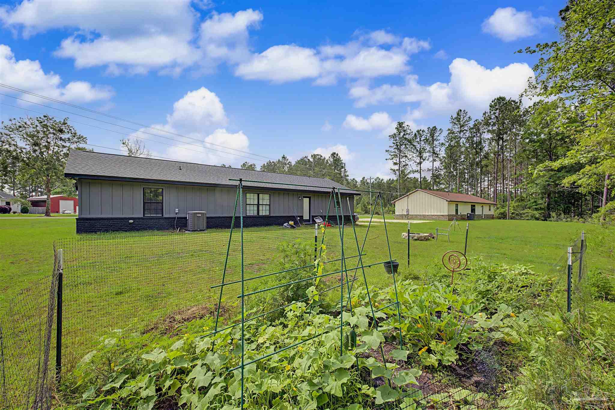 2549 Ten Mile Road Pace, FL 32571 - Photo 42 of 46 a view of an house with backyard space and balcony