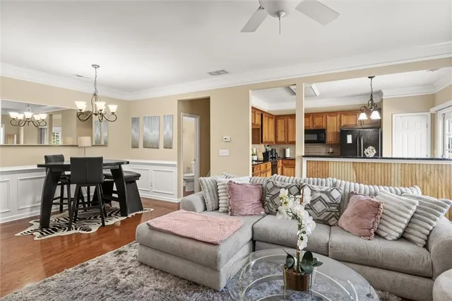 a living room with furniture and kitchen view