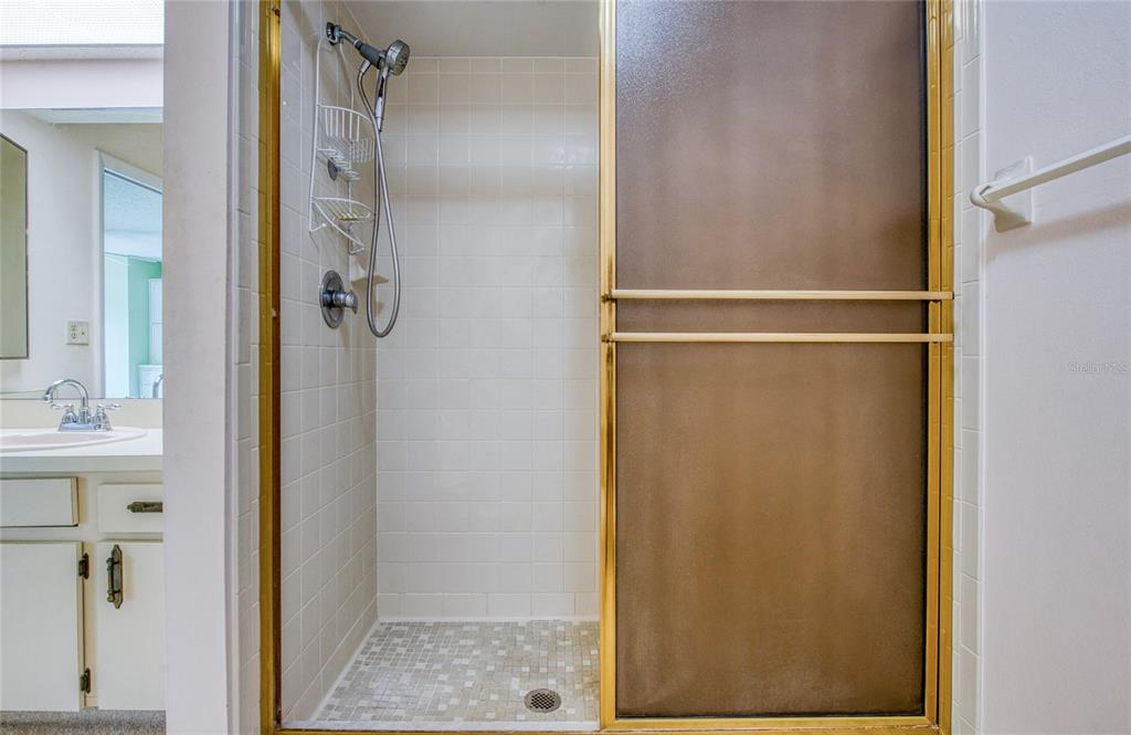 700 Starkey Road, Unit 1145 Largo, FL 33771 - Photo 29 of 63 a bathroom with a glass shower door