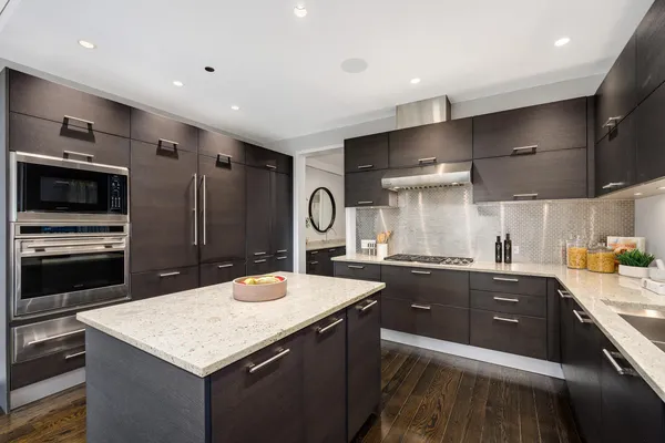 a kitchen with sink cabinets and stainless steel appliances