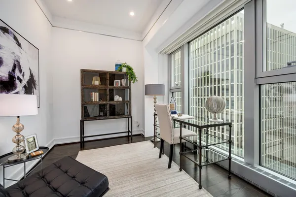 a living room with furniture and a floor to ceiling window
