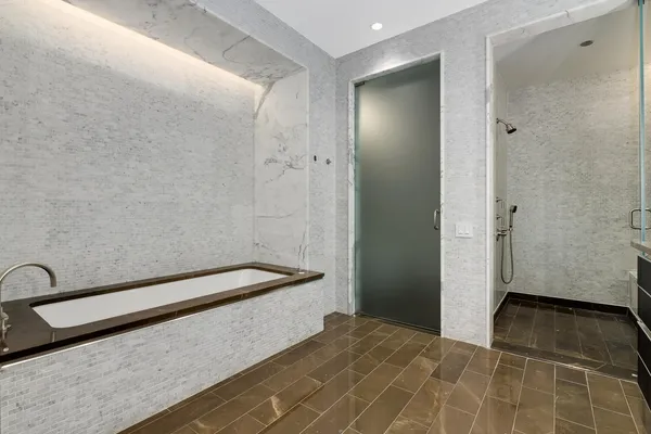 a bathroom with a bathtub and shower