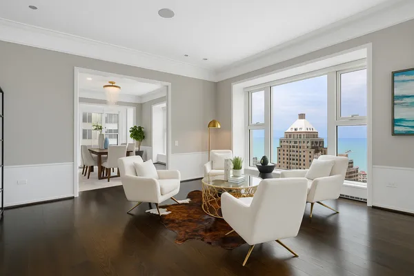 a living room with couches and a coffee table with wooden floor