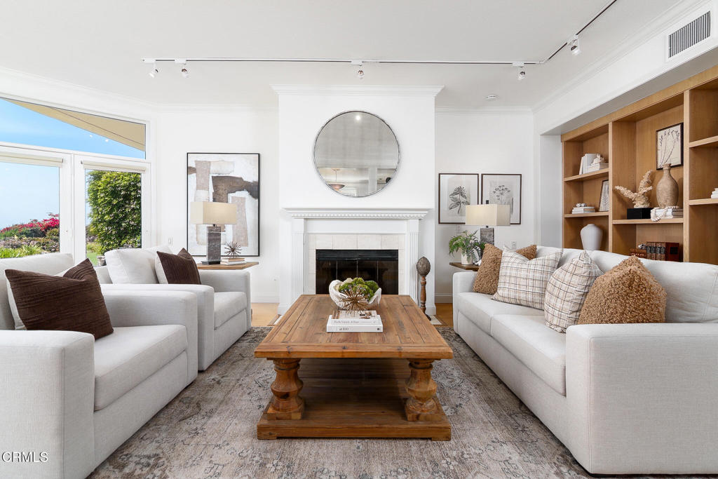 101 Rios Court Solana Beach, CA 92075 - Photo 9 of 67 a living room with furniture a large window and a fireplace