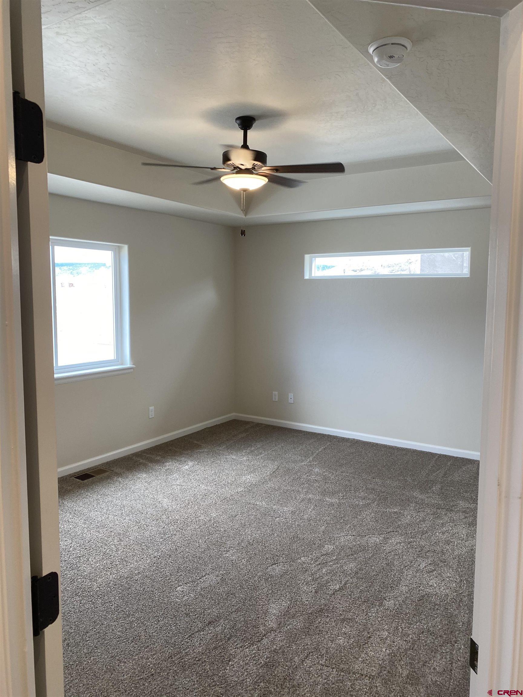 3672 Big Pines Loop Montrose, CO 81401 - Photo 11 of 19 an empty room with a ceiling fan and a window