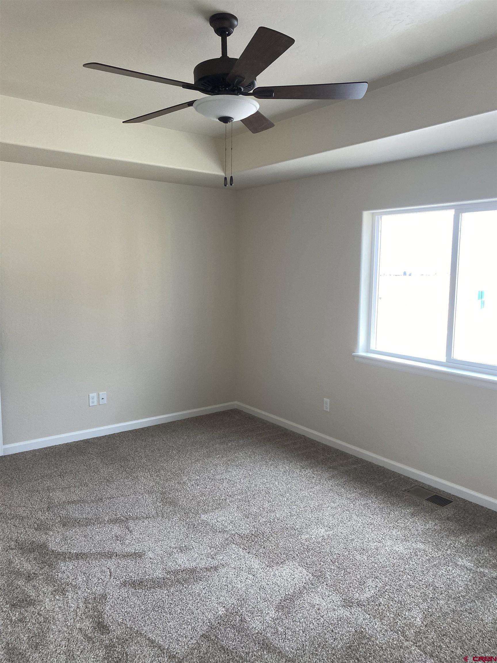 3672 Big Pines Loop Montrose, CO 81401 - Photo 14 of 19 an empty room with a window and a fan