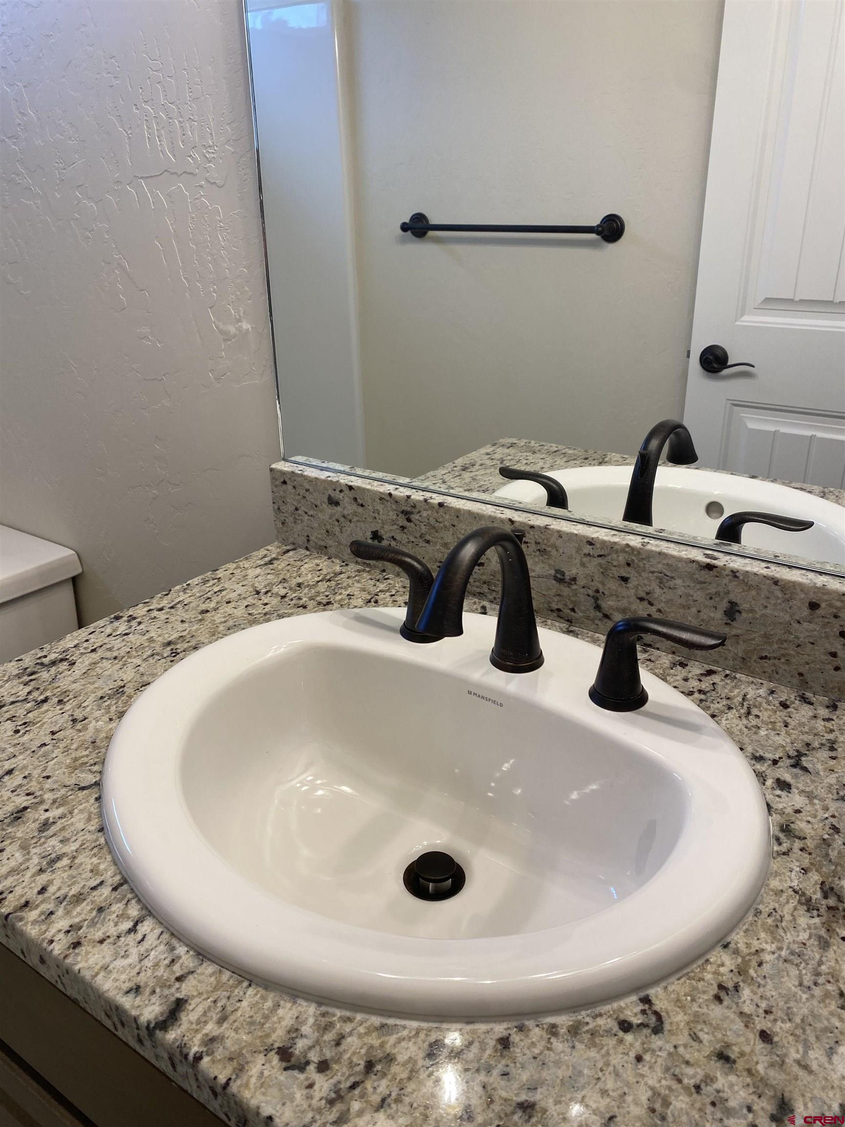 3672 Big Pines Loop Montrose, CO 81401 - Photo 18 of 19 a bathroom with a sink and a mirror