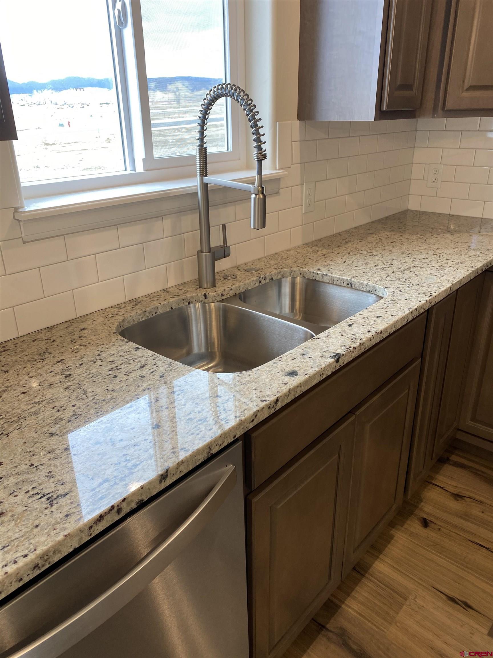 3672 Big Pines Loop Montrose, CO 81401 - Photo 5 of 19 a kitchen with granite countertop a sink and a window