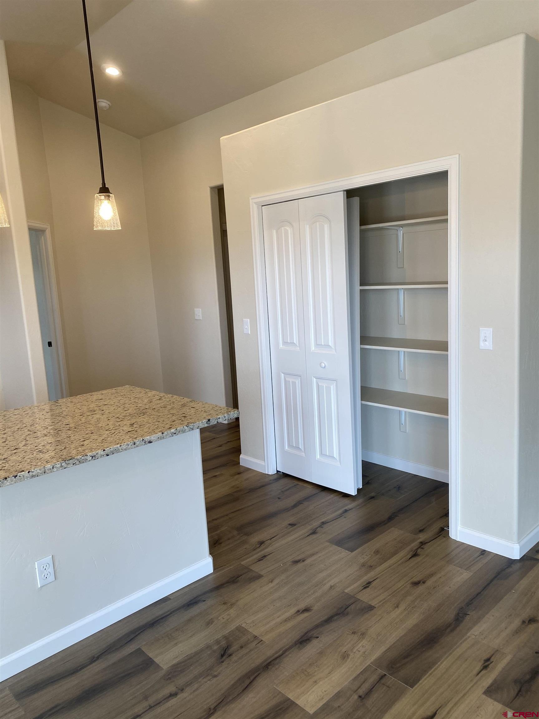 3672 Big Pines Loop Montrose, CO 81401 - Photo 6 of 19 a view of a room with wooden floor