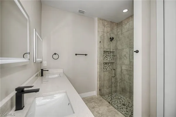 a bathroom with a shower and a sink