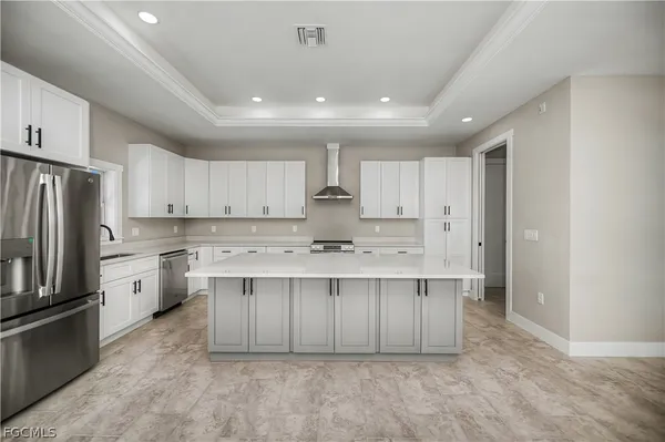 a large kitchen with kitchen island a sink stainless steel appliances and cabinets