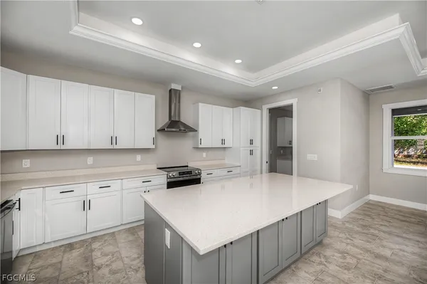 a kitchen with cabinets appliances and a window