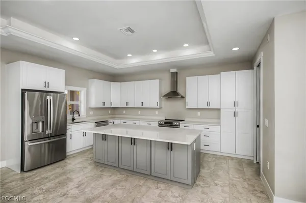 a kitchen with stainless steel appliances a refrigerator stove microwave and sink