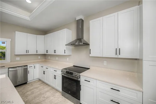 a kitchen with granite countertop white cabinets and white appliances