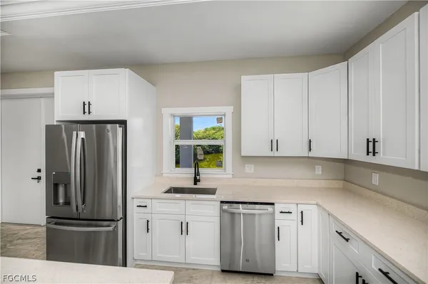 a kitchen with appliances a sink and a counter top space