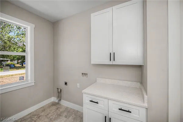 a kitchen with a white cabinets and a stove