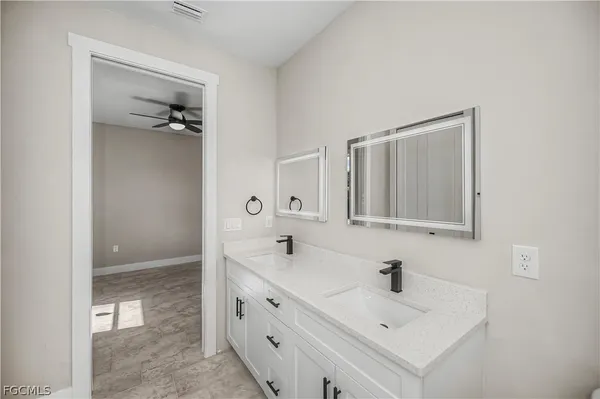 a bathroom with a sink a mirror and a shower