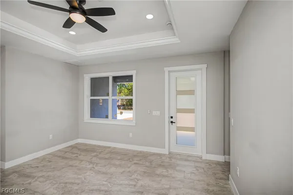 a view of empty room with wooden floor and window