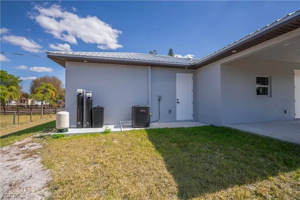 a view of a house with a backyard and a patio
