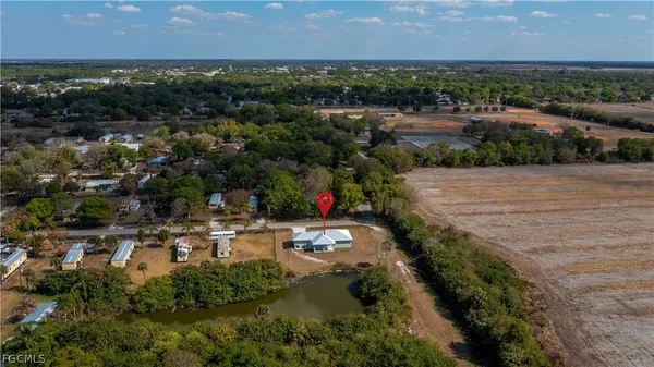 an aerial view of residential houses with outdoor space and lake view