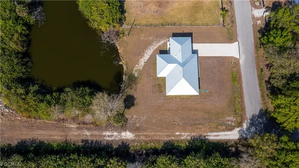 an aerial view of a house with yard