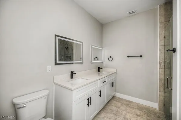 a bathroom with a double vanity sink and mirror