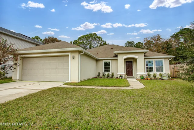a front view of a house with a yard and garage