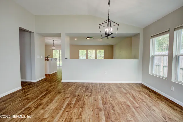 a kitchen with stainless steel appliances granite countertop a refrigerator a sink and a stove